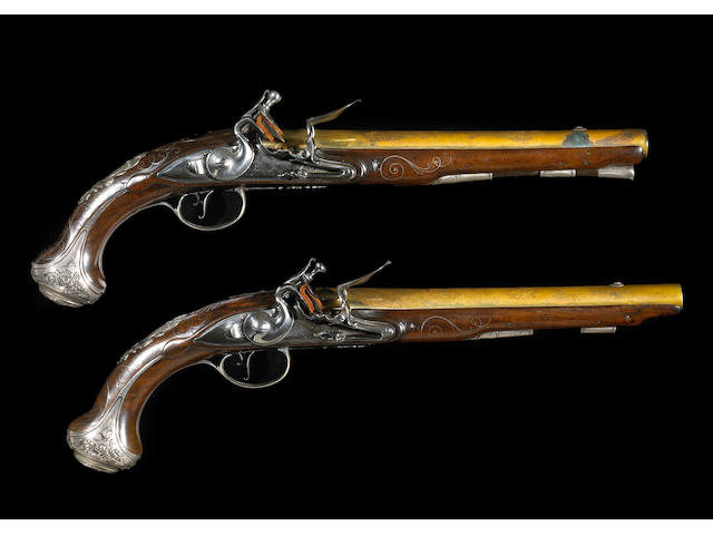 A pair of silver-mounted English flintlock pistols by John Bumford