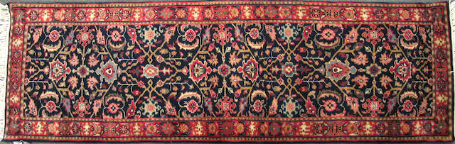 An Indian carpet size approximately 2ft. 7in. x 8ft. 2in.
