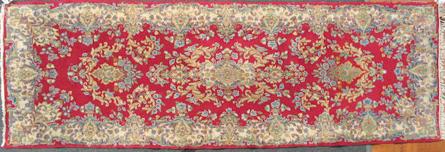 A Kerman carpet size approximately 2ft. 9 in. x 7ft. 7in.