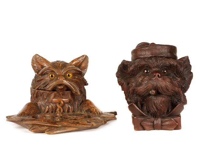 A group of two Continental carved walnut tobacco jars in the form of dogs