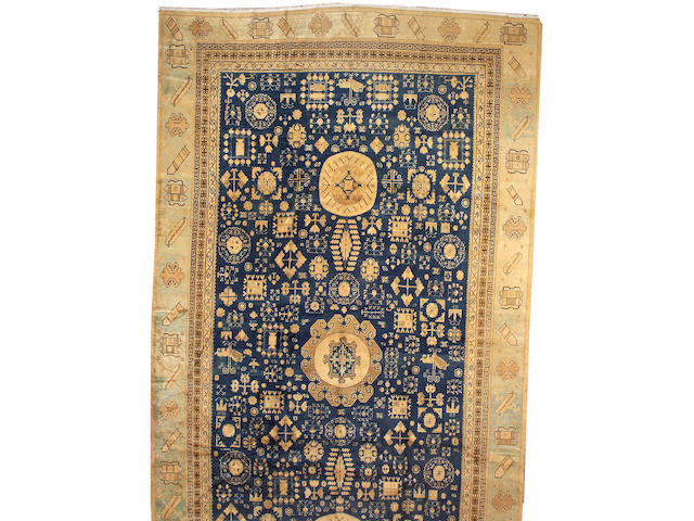 A Khotan carpet Turkestan, size approximately 10ft. 2in. x 19ft. 3in.