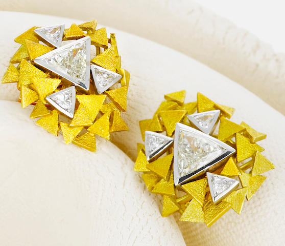 A pair of diamond and eighteen karat bicolor gold earclips, Andrew Grima,