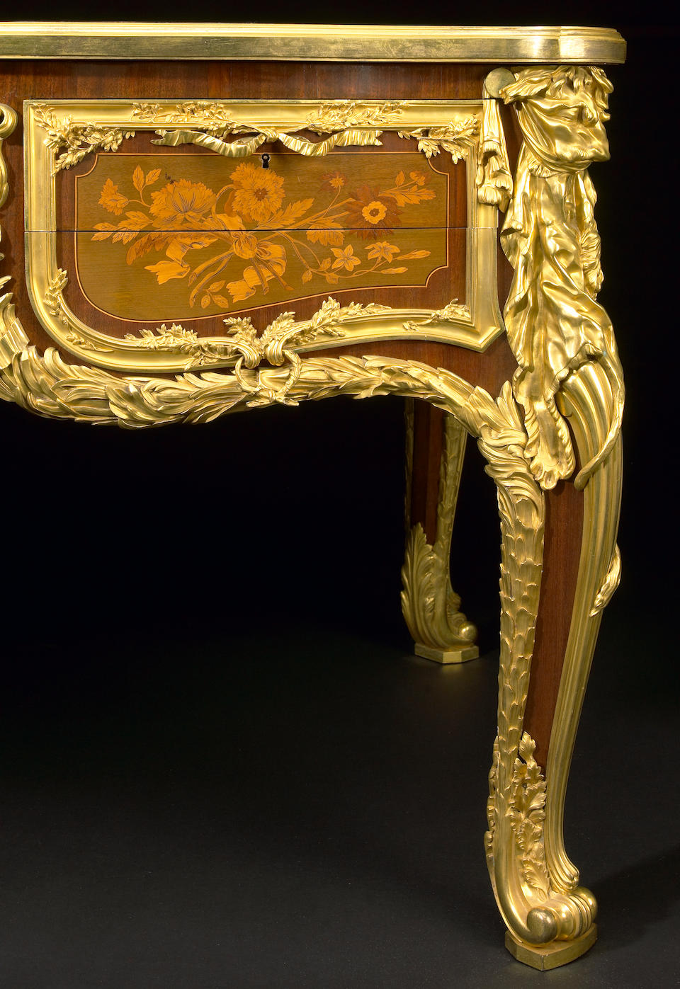 An impressive Louis XV style gilt-bronze mounted marquetry inlaid and bisque porcelain inset bureau plat  Maison Krieger after the bureau du roi by J. -F. Oeben and J. -H. Riesener circa 1900