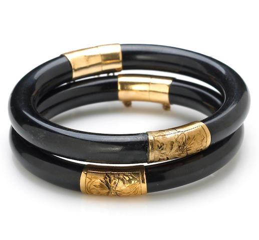 Bonhams : A pair of black onyx bangle bracelets