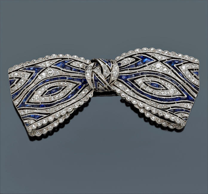 A diamond and sapphire bow brooch