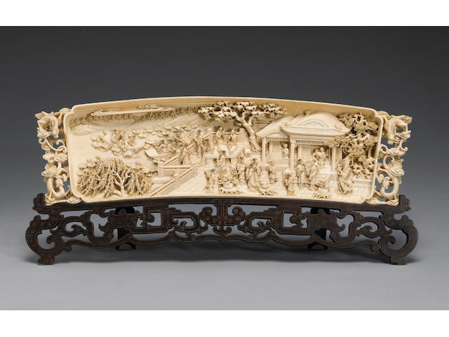 A carved ivory plaque depicting a garden scene 20th Century