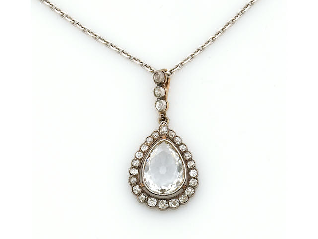 A diamond and silver-topped eighteen karat gold pendant with chain