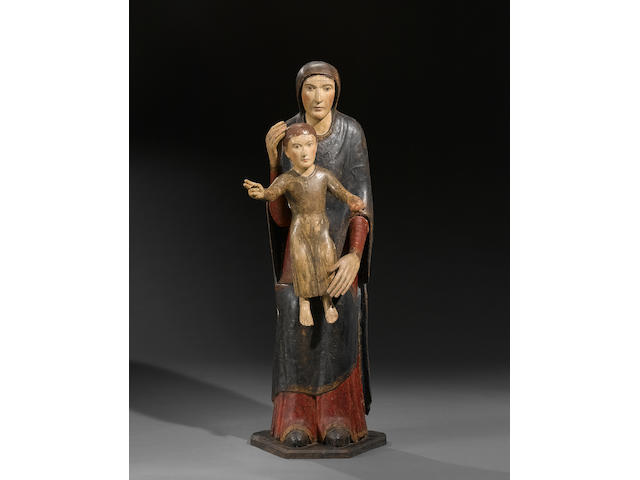 A Spanish Romanesque style carved wood and polychrome decorated figure of the Virgin and Child  probably 13th century, restored