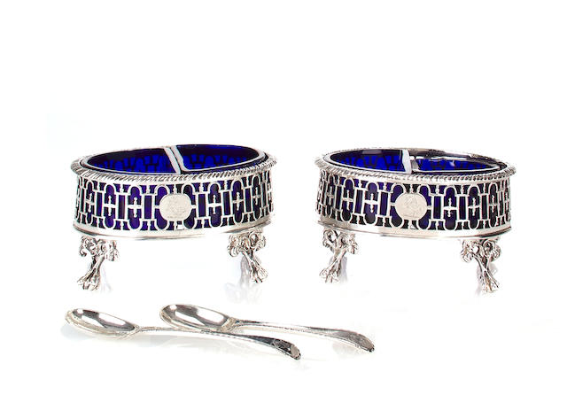 A pair of George III pierced silver oval salts with divided cobalt glass liners and silver spoons James Young, London, 1771