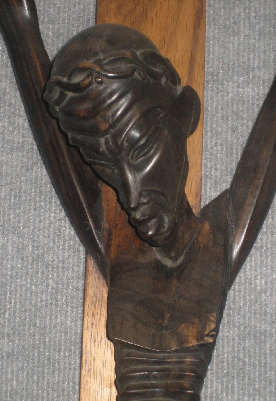 A Contemporary African carved wood crucifix signed Hginamau, 1988