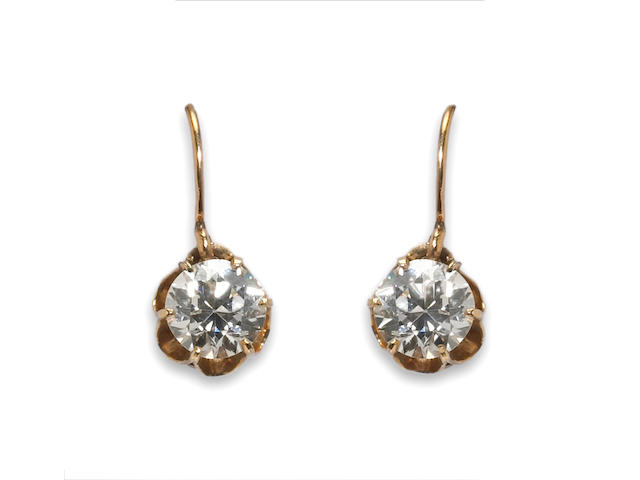 A pair of diamond solitaire earrings