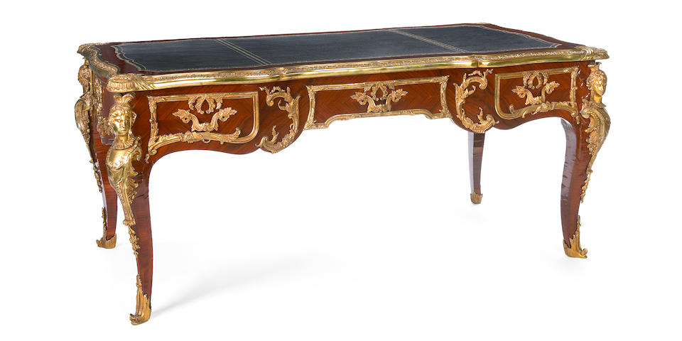 A Louis XV style gilt bronze mounted walnut bureau plat