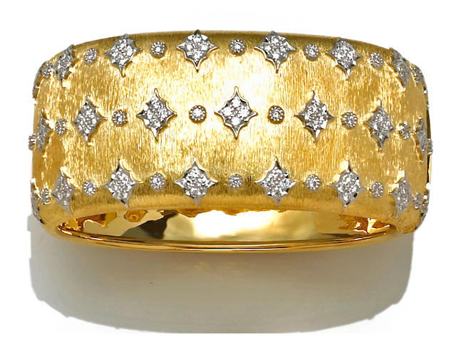 A diamond and eighteen karat bicolor gold bangle bracelet