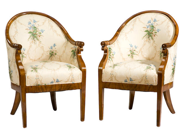 A pair of late Empire walnut tub armchairs