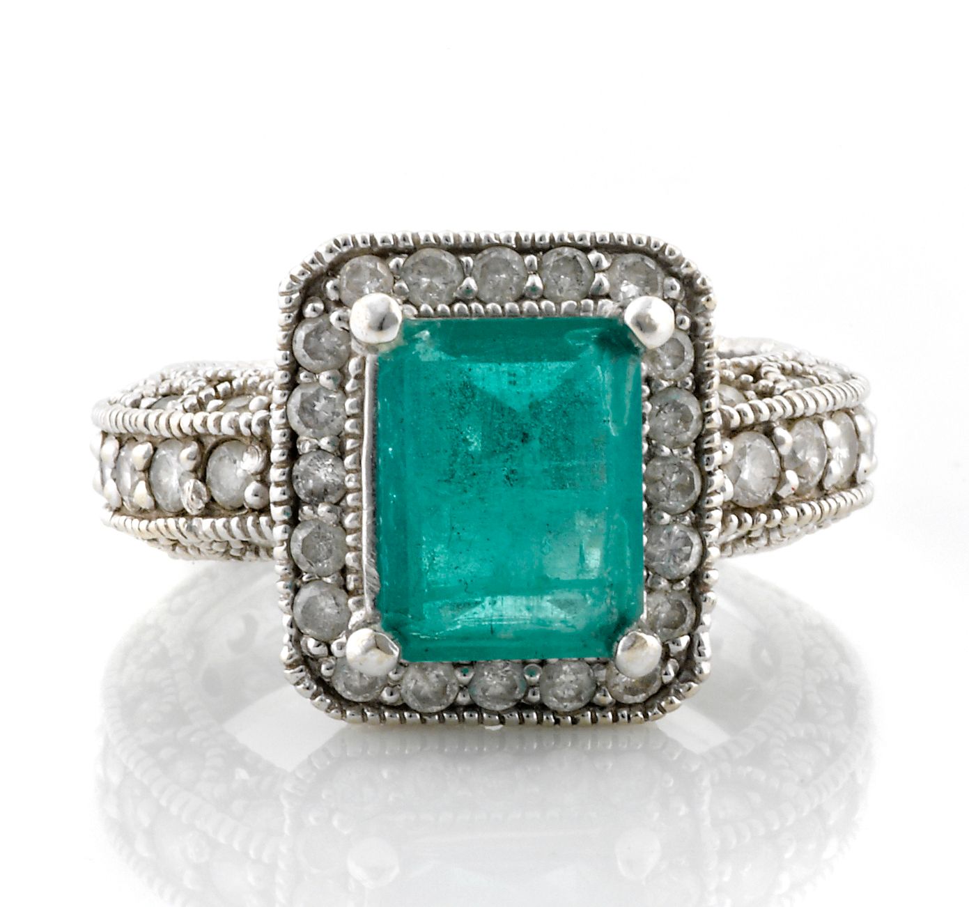 An emerald and diamond ring