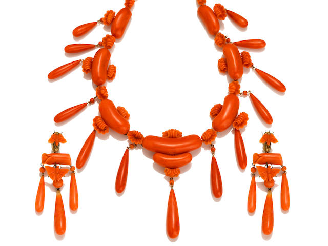 A carved coral necklace together with pendant earclips, retailed by Marsh & Co.