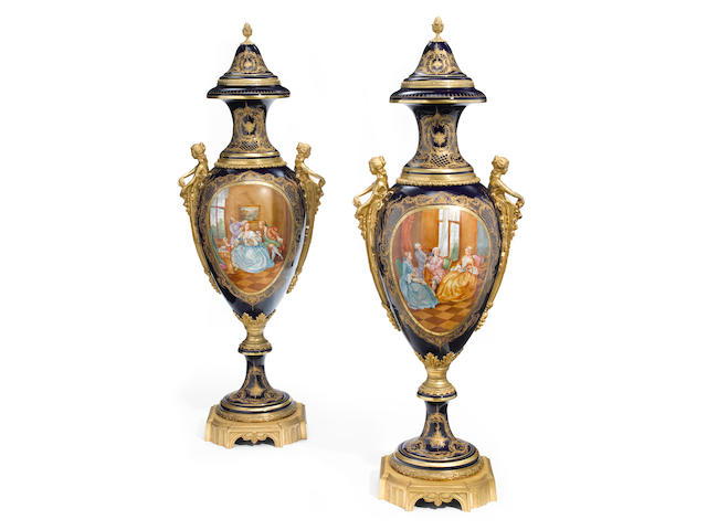 An imposing pair of S&#232;vres style porcelain gilt bronze mounted covered urns  20th century