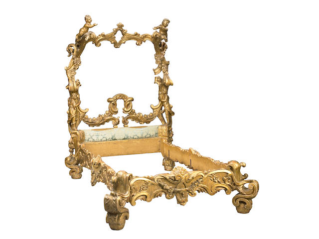 An imposing Venetian Rococo style carved giltwood bed
