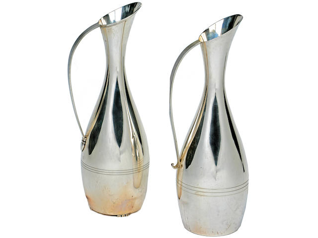 A near pair of American sterling silver tall and attenuated pitchers by L. Huemer, mid-20th century