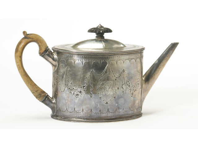 A George III silver beaded oval teapot with bright cut decoration and wooden fittings by Thomas Daniel, London, 1786, stamped: Silver*Lion, Foster Lane With original and later monograms
