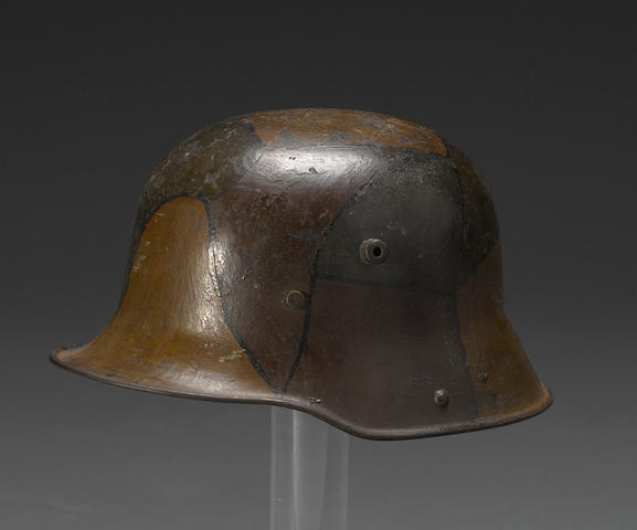 A German Model 1916 three-color camouflage helmet