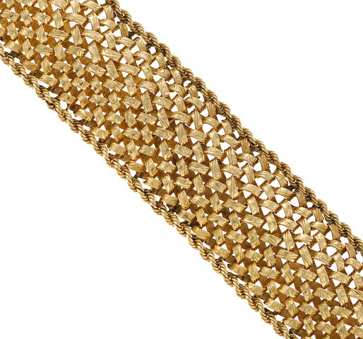 A fourteen karat gold wide woven style bracelet