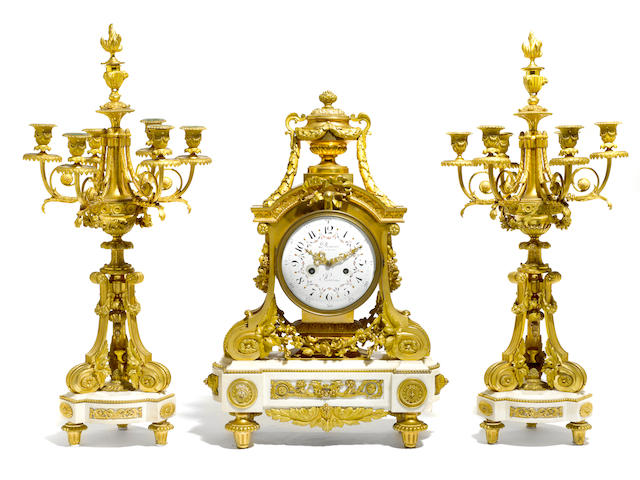 A fine and rare Louis XVI style gilt bronze and marble double-sided clock and matching candelabra  Deni&#232;re &#224; Paris second half 19th century
