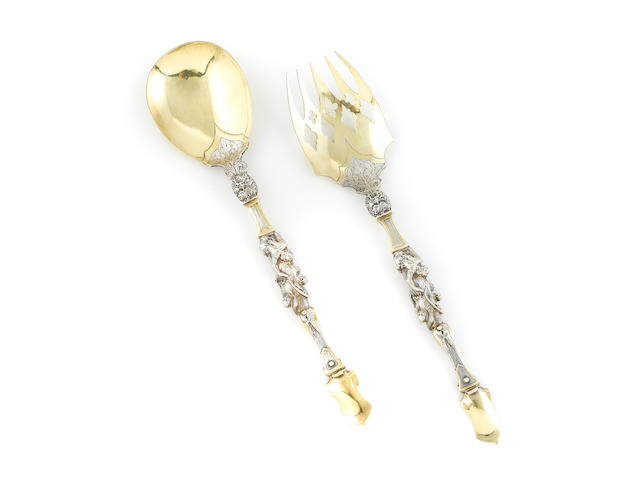 A pair of Victorian parcel-gilt sterling silver heraldic servers by Charles Edwards, London, 1879