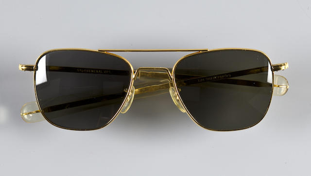 WALLY SCHIRRA'S PILOT SUNGLASSES. SCHIRRA ON SPORTS CARS AND MORE! Standard-issue military sunglasses by General Optical, in gold-colored metal with straight-prong supports and green-gray lenses.