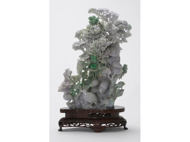 A mottled jadeite carving of chrysanthemums and birds