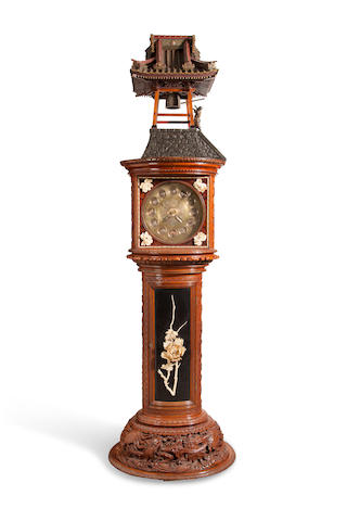 A Remarkable elaborately carved and inlaid automaton striking hall clock Commissioned from Tiffany & Co., New York, the case Japanese, fitted with Tiffany movement No. 759, delivered in April 1901