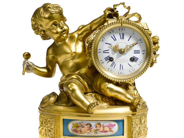A Louis XVI style gilt bronze and porcelain mantel clock