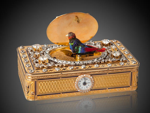 A fine and rare diamond-set engraved and enameled gold singing bird snuff box with musical movement and watch The box with the lozenge maker's mark of Jean-Georges R&#233;ymond, Geneva 1798 - 1815, and the mark of les fr&#232;res Rochat, the movement stamped with serial number 7, circa 1804, and later embellished