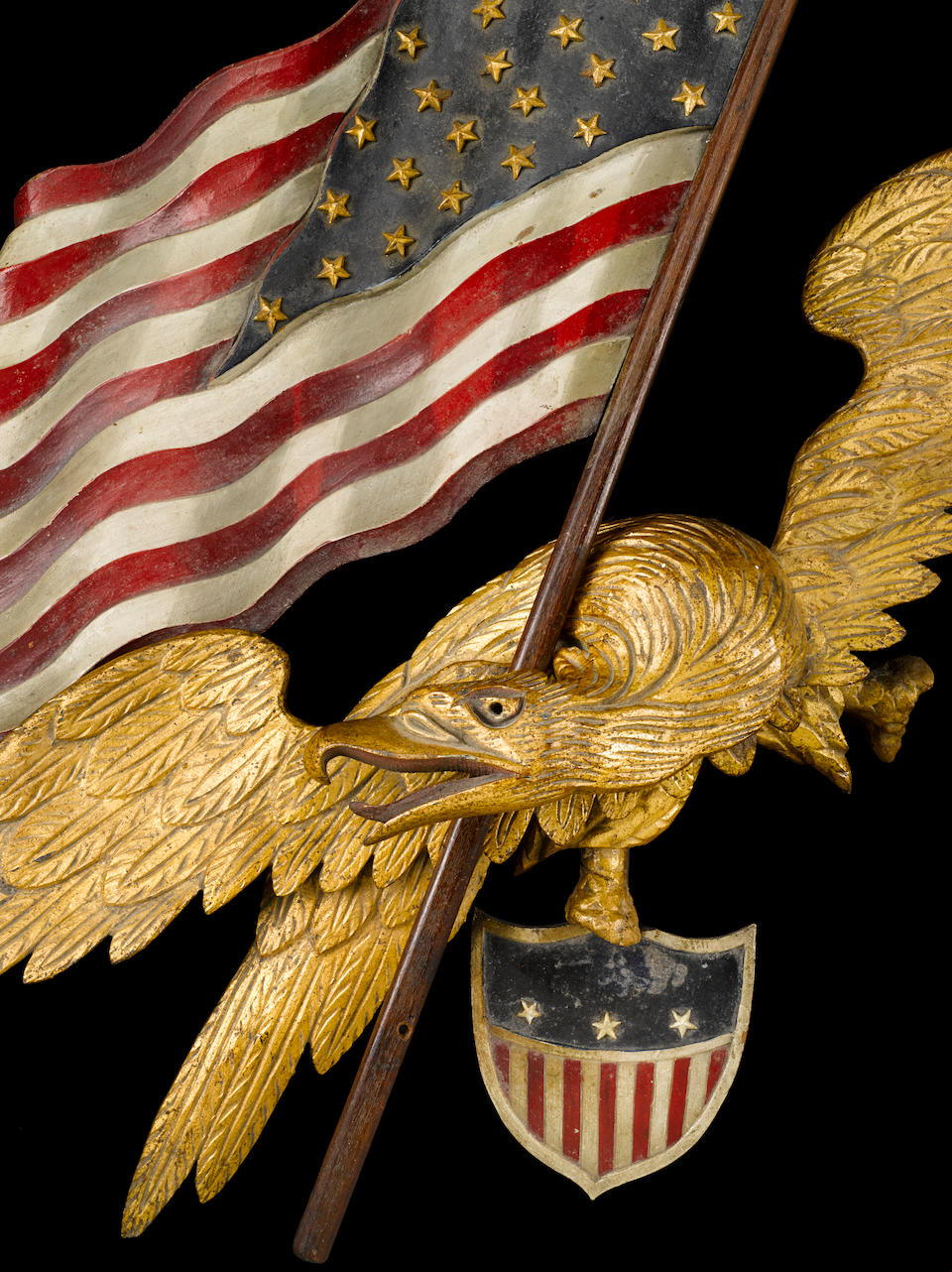 A carved and polychromed wing-spread eagle with flag and shield attributed to George Stapf (American, 1862-1958)  probably Harrisburg, Pennsylvania, 1890-1910