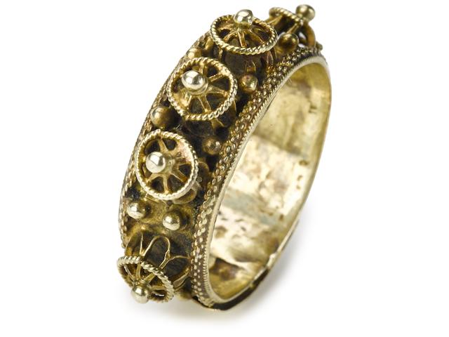 A Continental gold marriage ring 17th century  with band applied with bosses and graining; surmounted by a plaque with a Hebrew inscription.