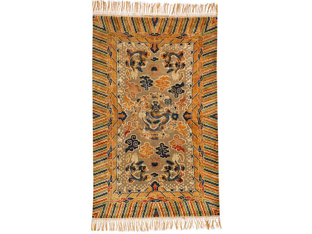 A Chinese metal and silk rug China size approximately 4ft. 10in. x 7ft. 9in.