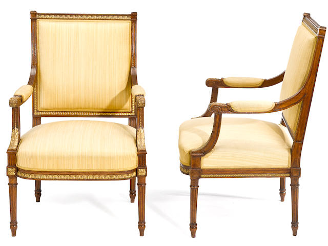 A pair of Swedish Neoclassical parcel gilt walnut armchairs 19th century