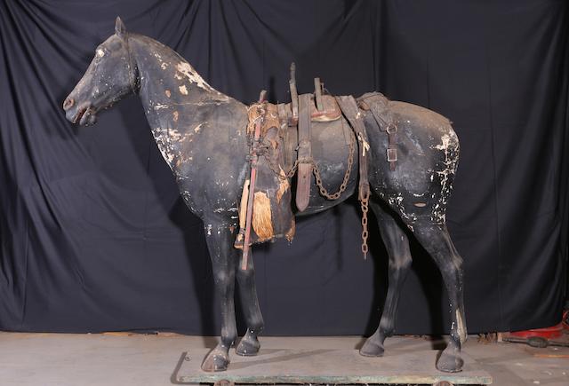 A full-size black with spots plaster horse,