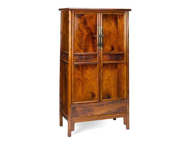 A tall hardwood rounded-corner tapered cabinet