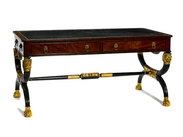 A Regency style parcel gilt and ebonized mahogany partner's writing desk
