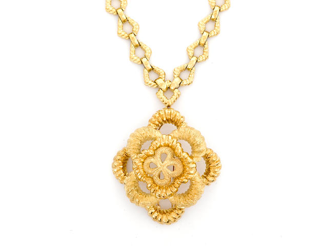 An eighteen karat gold pendant/brooch with chain