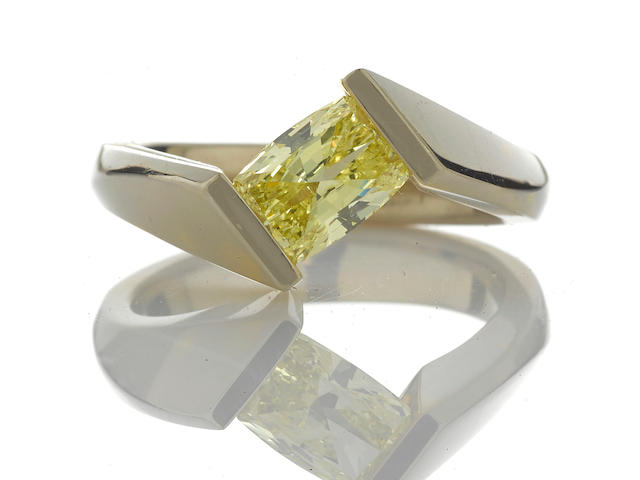 A fancy intense yellow diamond solitaire ring