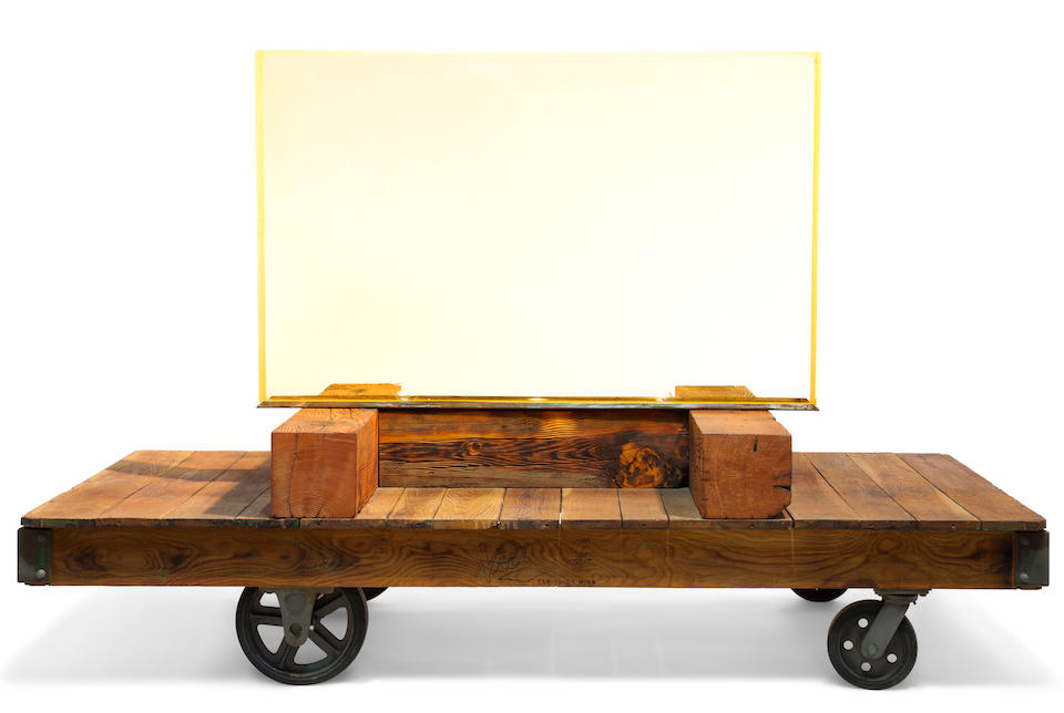 MANHATTAN PROJECT VIEWING WINDOW. An approximately 54 x 36 inch rectangle of heavily leaded glass, 6 inches thick, approximately 1500 lbs, on custom antique wooden cart, glass illuminated from below with 3 custom LED lights.