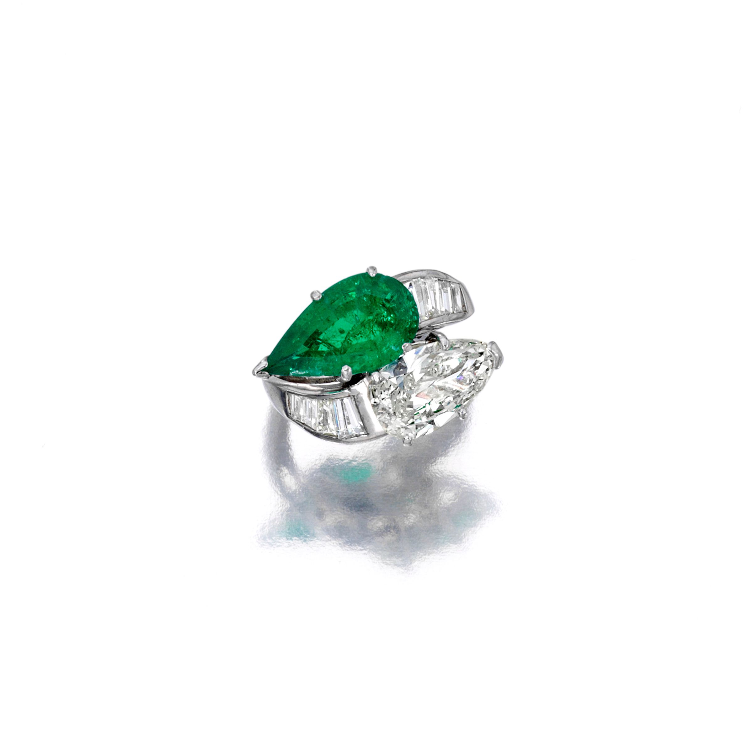 A diamond and emerald ring