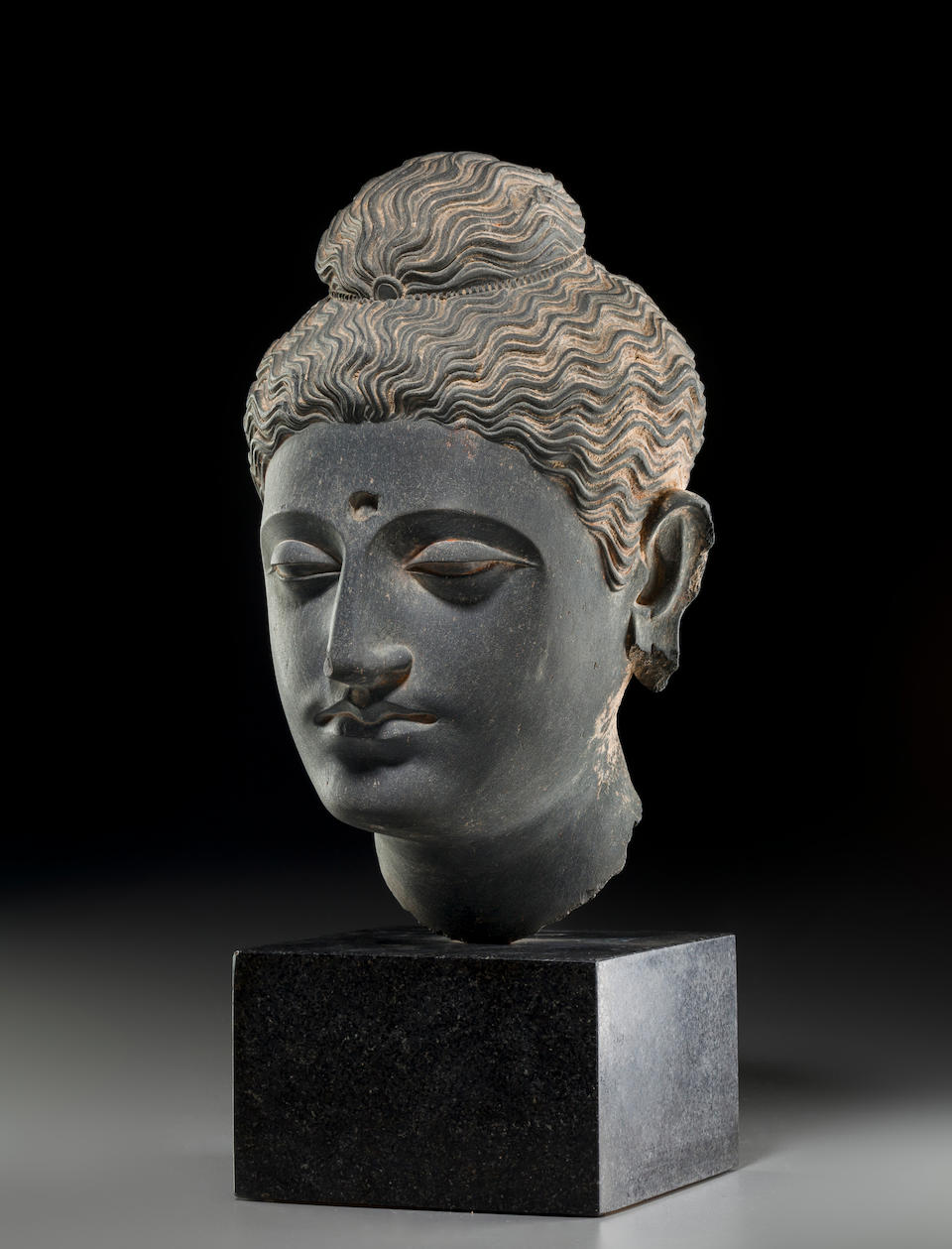 A carved schist head of Buddha Ancient region of Gandhara, 3rd/4th century