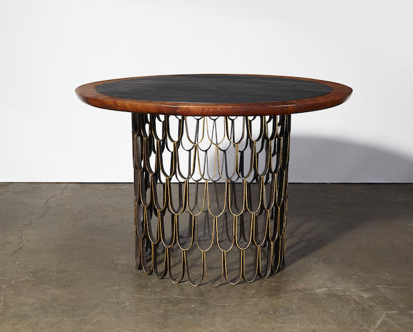 Paul Evans and Phillip Lloyd Powell Dining tabledesigned and executed circa 1960band iron, walnut, and gold leaf, slate height 26 1/4in (66.5cm); diameter 42in (107cm)