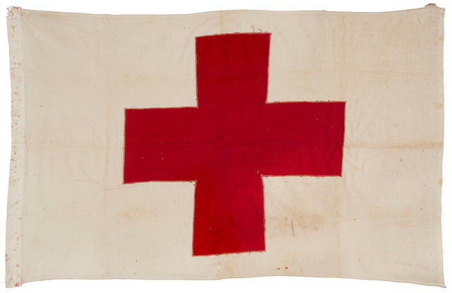 A D-Day Red Cross Flag and US Navy Buckler Foul Weather Parka worn by seaman C.W. Weiss on one of the First Boats, LCT-537, to land on Omaha Beach, Normandy, June 6, 1944 Red Cross flag: 22 x 31 in (56 x 79 cm) 2