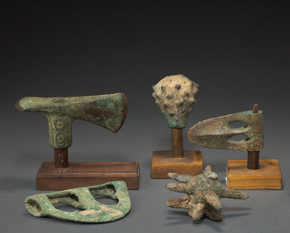 A lot of three Bronze Age axe heads and two mace heads