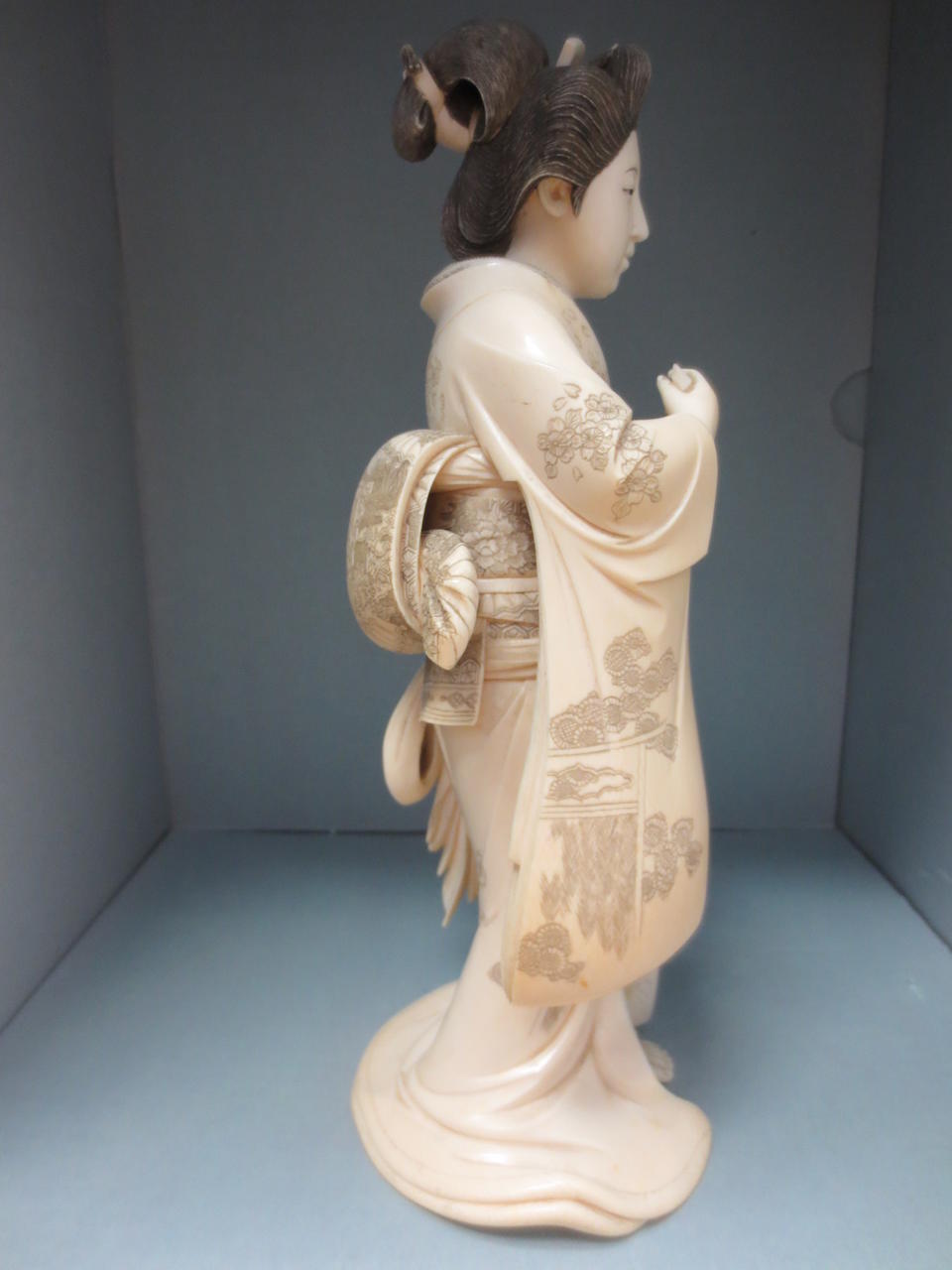 An ivory okimono of a geisha Meiji era, late 19th century