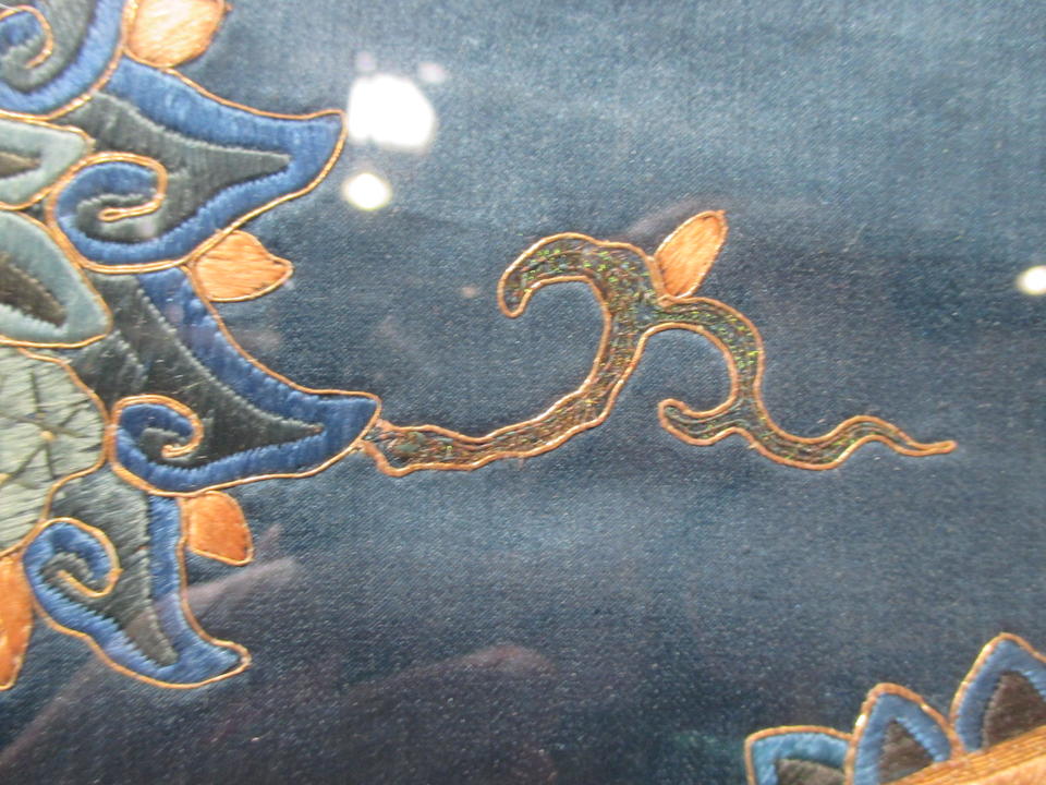 A blue silk ground vertical panel embroiderd in gilt-wrapped threads 19th century